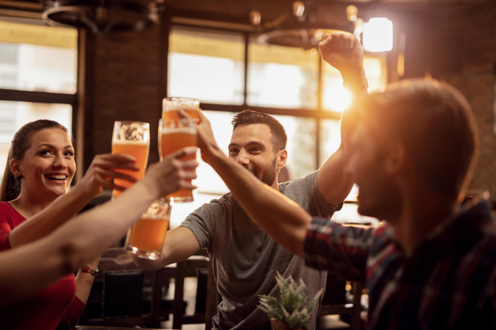 group happy young people toasting with beer having fun pub